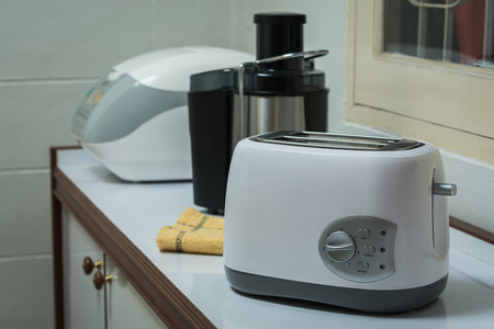 Electric appliances in a kitchen, toaster, juice extractor and  rice cooker