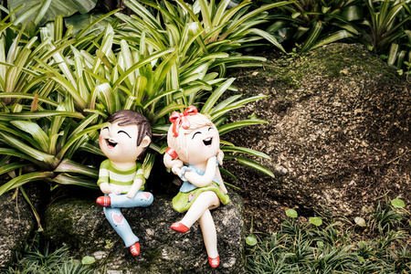 Little ceramic dolls are decorated in the gardenの写真素材