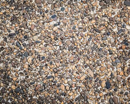 Texture of many little stone are in concrete floor background