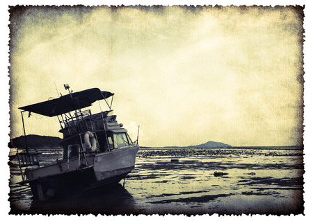 Motor boat on old burnt paper sheet in vintage style isolated on white for your textの写真素材