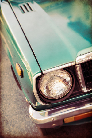 Front side of green old car in vintage style backgroundの写真素材