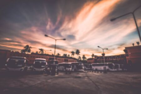 Abstract of blurred many bus in the parking under dramatic skyの写真素材