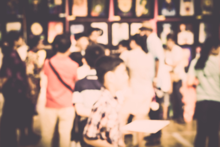 Blurred crowd of people watching art exhibition in the hall for backgroundの写真素材