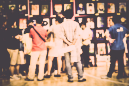 Blurred crowd of people watching art exhibition in the hall for backgroundの写真素材