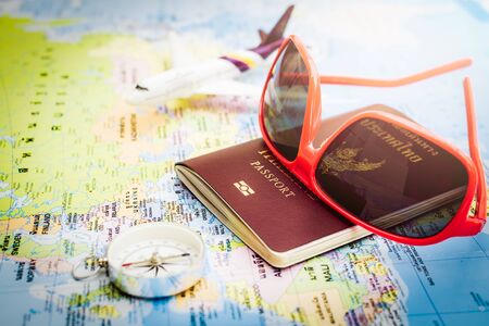 Travel concept, Red sunglasses, passport, compass and aircraft on europe mapの写真素材