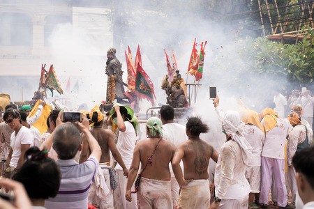 PHUKET- OCT 07 : Taoism participants in a street procession of the Phuket Vegetarian Festival on Oct 07, 2016 in Phuket, Thailand. During festival devotees abstain from eating meat to appease the God.のeditorial素材