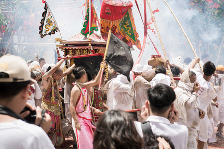 PHUKET- OCT 07 : Taoism participants in a street procession of the Phuket Vegetarian Festival on Oct 07, 2016 in Phuket, Thailand. During festival devotees abstain from eating meat to appease the God.のeditorial素材