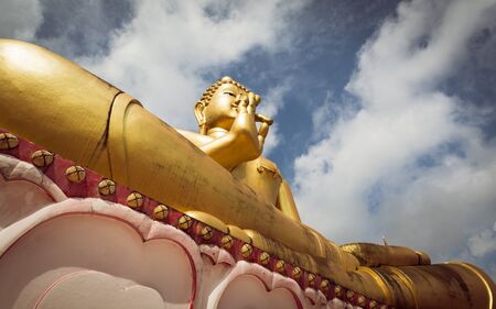 Giant sitting buddha on Rang Hill Temple ( Wat Khao Rang ) with blue sky in Phuket, Thailand
