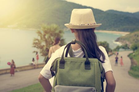 Girl with backpack viewing to the sea during sunset in phuket.の写真素材