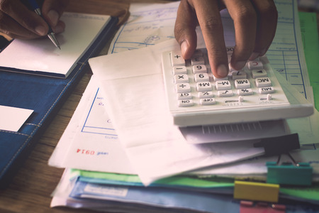 Hands of people calculating his expenditure, Finance concept.の写真素材