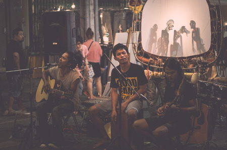 PHUKET, THAILAND-FEBRUARY 23, 2018 : Folk music band is performing on the street at night in phuket, Thailand.のeditorial素材