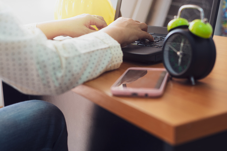 Businesswoman typing laptop on working desk in office.  Business and technology concept.
