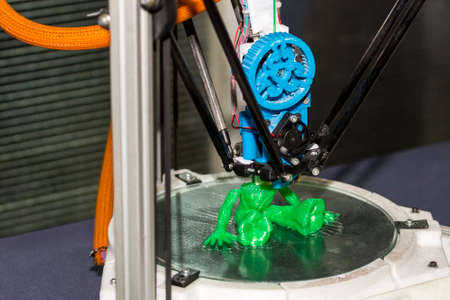 three dimensional (3d) printer machine working plastic toy model at factory