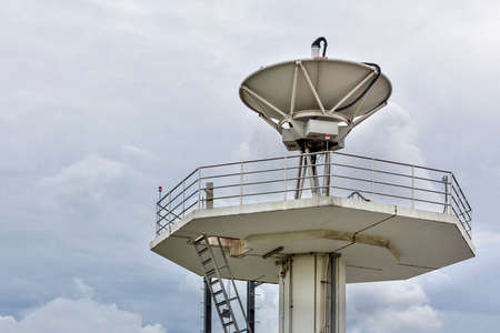 High technology satellite dish station on cloudy sky day backgroundの写真素材