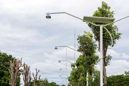 solar street lamp at public park on cloudy and blue sky background