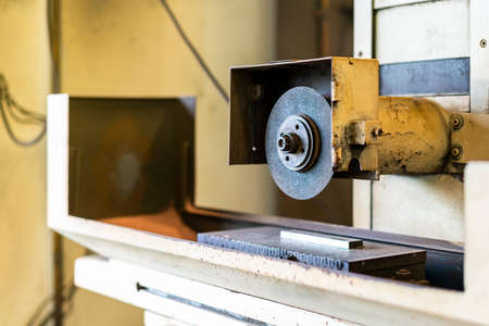 Close up cutting or grinding wheel of high accuracy surface horizontal grinding machine for finishing process in industrial metal work at factoryの写真素材