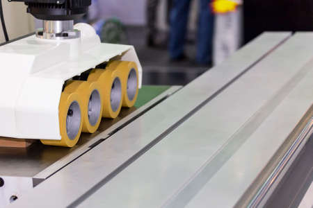 close up automatic wheel power feeder for woodworking router panel cutter machine for industrialの写真素材