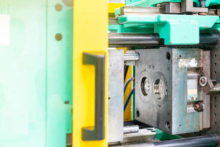 metal mould or plastic injection mold setup on high pressure injection molding machine for mass production or manufacturing in industrialの写真素材