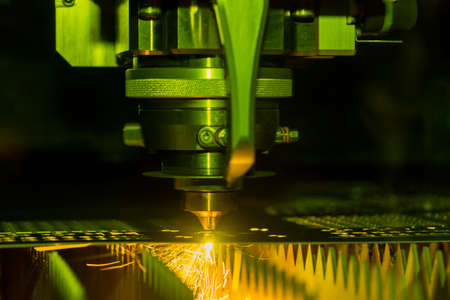 Close up Industrial laser and plasma cutting of steel sheet or metal sheet with sparks fly