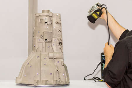 engineer or operator who prepare emits pink light laser from a portable 3d scan (high accuracy...