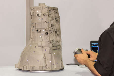 engineer or operator who prepare emits pink light laser from a portable 3d scan (high accuracy...