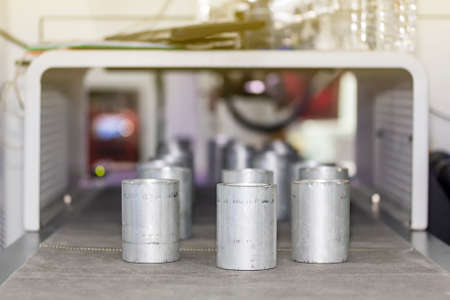 Many short pipe product on automatic belt conveyor during manufacturing process in factory
