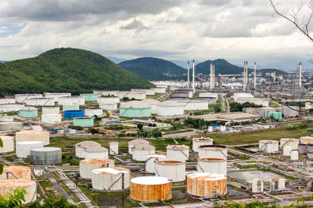 View of tank with oil refinery and petrochemical industrial plant with background cloudy sky and...