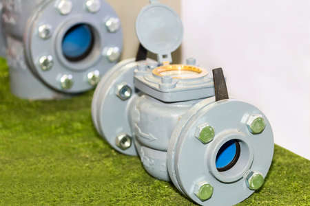 Close up flow and control meter for industrial work on green ground