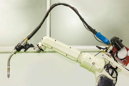 close up industrial weld robot arm with mig electrode holder or torch for industrial at factory.