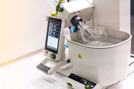 Close up distillation flask of high technology rotary vacuum evaporator in chemical laboratory for...