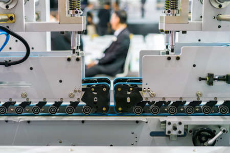 Close up blue belts feed wheel unit of high technology and automatic modern of machine for paper box...