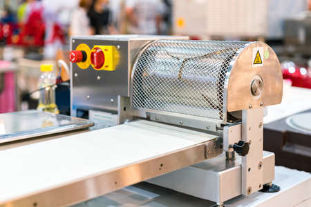 modern and high technology dough sheeter machine for preparing dough and making pastry in industrial food or bakeryの写真素材