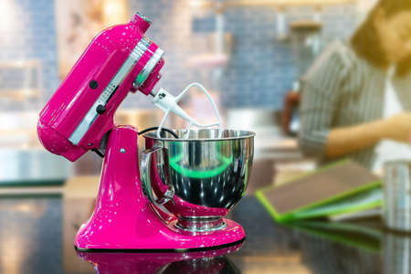 Pink color stand food mixer machine for industrial or home on blur backgroundの写真素材