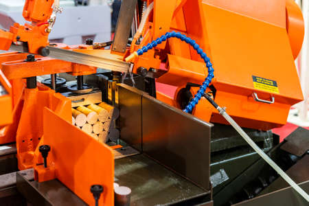 Many round shaft steel is being cutting by automatic continuous and high speed horizontal band saw...