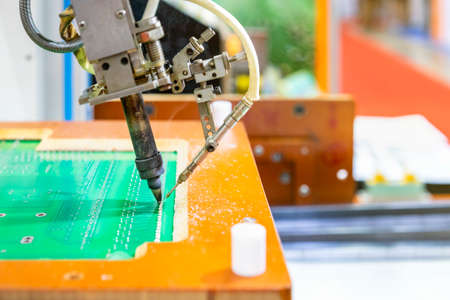 Close up iron tip of High technology and modern automatic robot for pcb (print circuit board)...