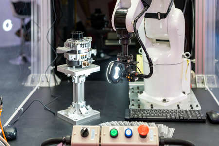 high technology and precision robot grip with automated vision inspection camera for check or measuring product or work piece on table in manufacturing process at factory or work shopの写真素材