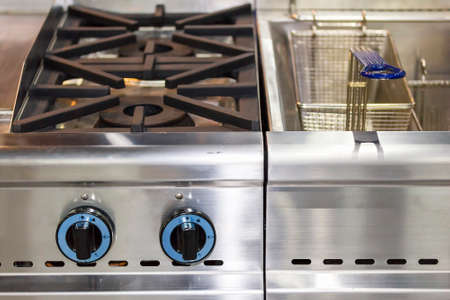 modern gas stove made from steel or cast iron or copper with deep fryer pot with stainless basketの写真素材
