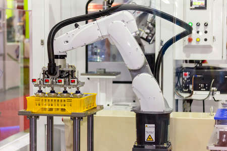 high technology of precision and accuracy industrial robot arm during working put glass bottle in...