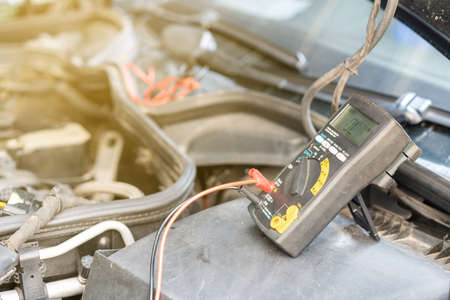 close up electronic multi meter device or tool during use for electric system check of car repair on...