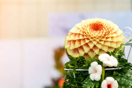 Colorful and beautiful watermelon carved or sculpted on green leaf with copy spaceの写真素材