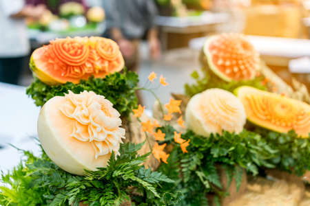 Many colorful and beautiful fruit carved or sculpted such as watermelon cantaloupe pumpkinの写真素材