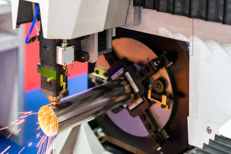 close up nozzle of high precision cnc plasma laser cutting machine during engrave or perforate...