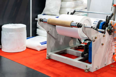 Raw material plastic roll set on auto feed shaft support of high technology and automatic high speed continuous manufacturing process plastic bag sack or plastic envelope making machine for industrialの写真素材