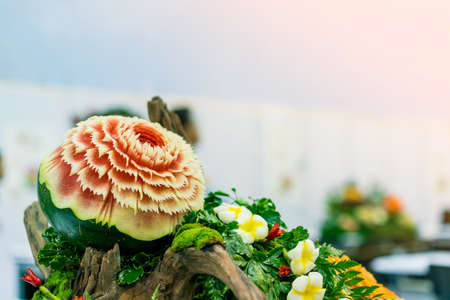 Colorful and beautiful watermelon carved or sculpted on green leaf with copy spaceの写真素材