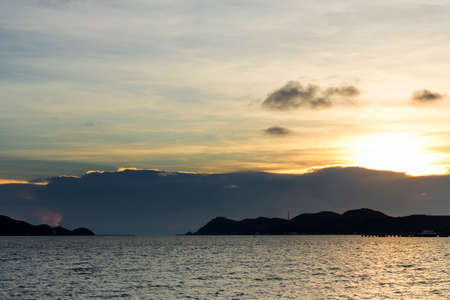 beautiful seascape, golden sunset behind island and above the sea at asiaの写真素材