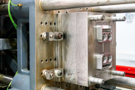 metal mould or plastic injection mold setup on high pressure injection molding machine for mass production or manufacturing in industrialの写真素材