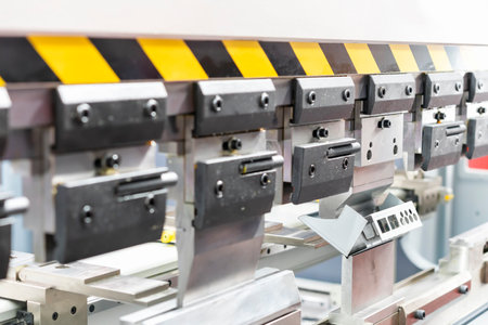 Close up teeth of the semi automatic hydraulic bending machine and the metal sheet or the workpiece...