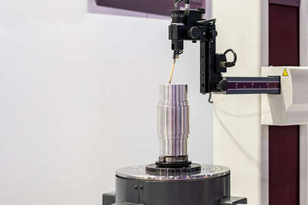 Machining cylindrical metal part set on work turntable on roundness cylindricity and straightness...