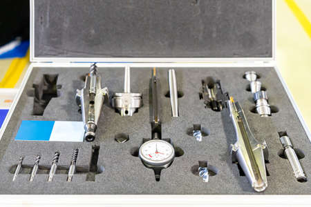 Sample cross section tool holder with dial gauge end mill and other various equipment for cnc machining center process in boxの写真素材