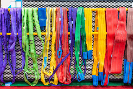 various multi color such as red green yellow blue purple violet gray brown of flat webbing sling or polyester belt for lift and move heavy workpiece or etc in industrialの写真素材